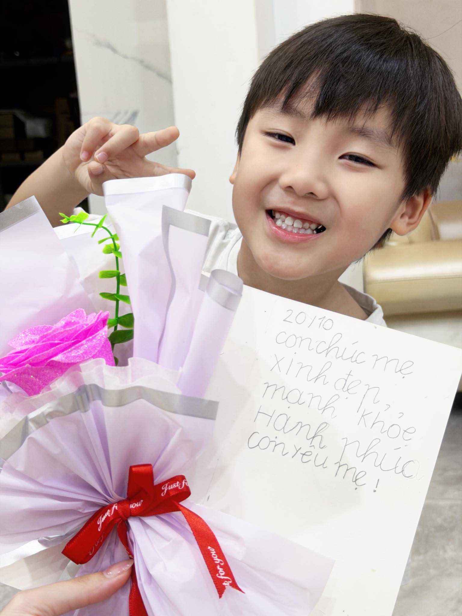 Ảnh bé Bo cầm hoa tặng mẹ